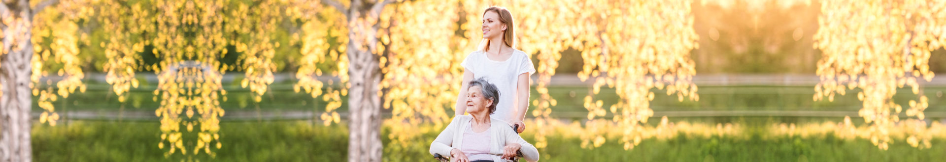 caregiver and senior woman at the park