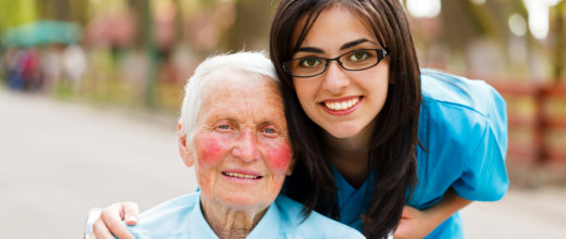 senior woman smiling with her caregiver